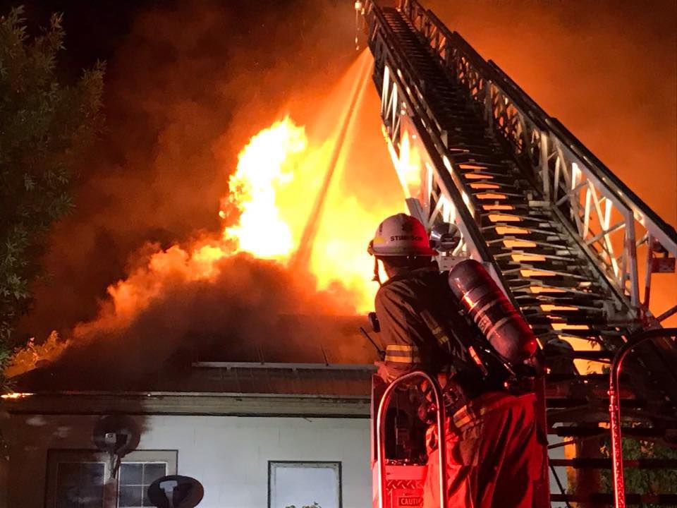 Firefighters spray down apartment blaze